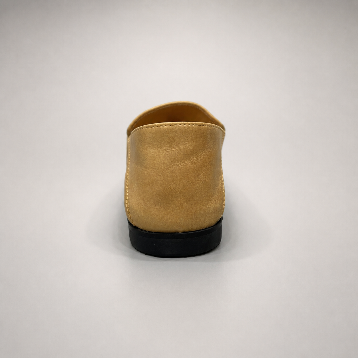 Tan loafer rear view showing a metal accent across the vamp