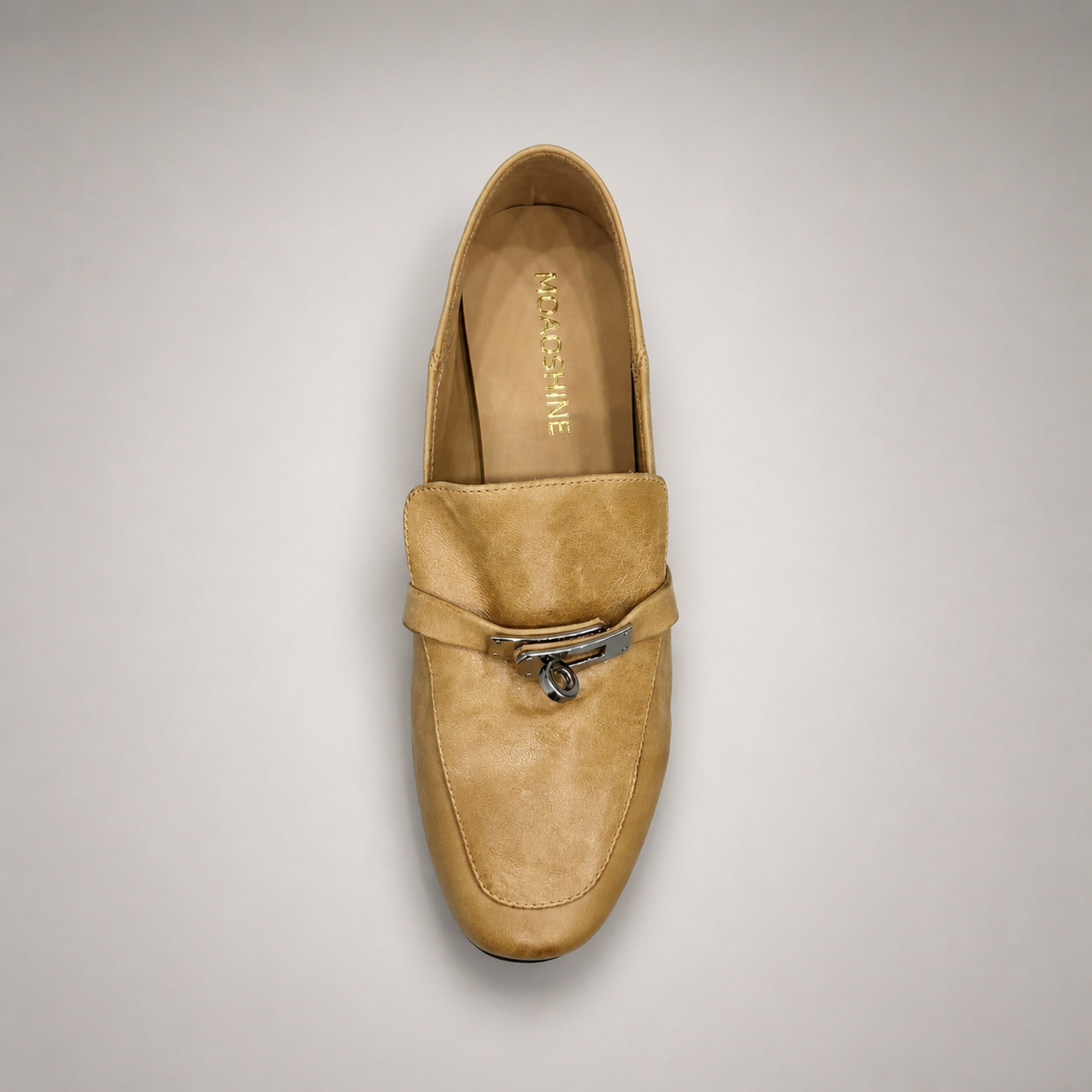 Tan loafer top view showing a metal accent across the vamp