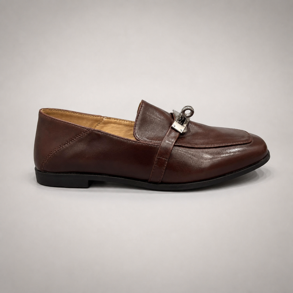 Brown loafer side profile showing a metal accent across the vamp