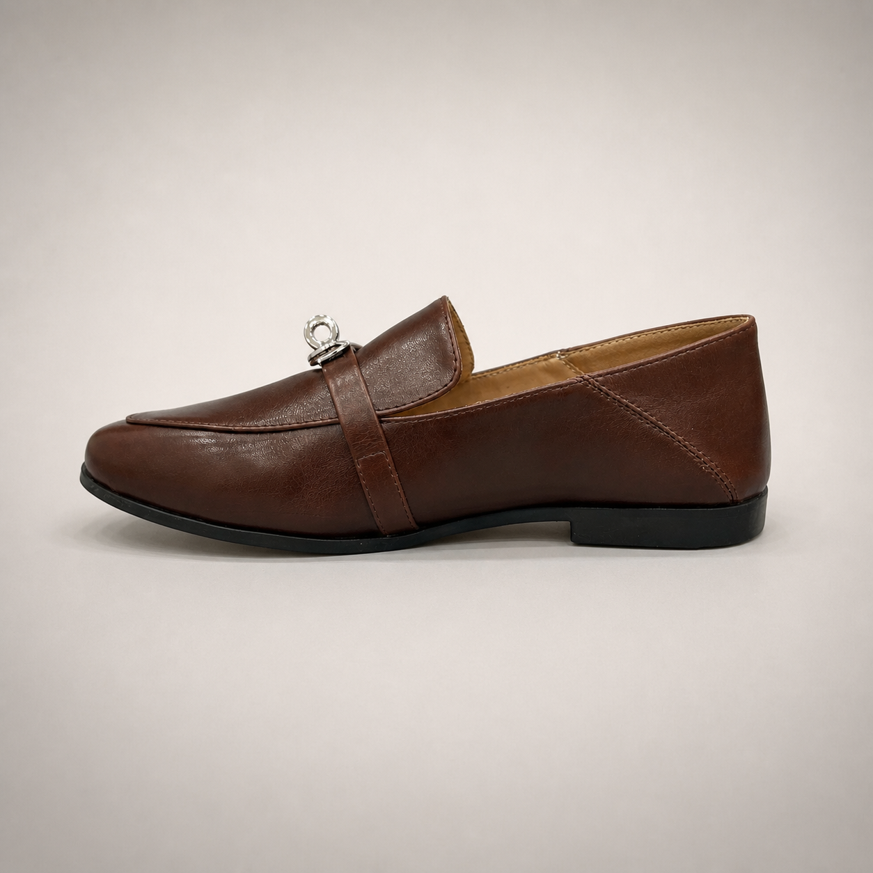 Brown loafer opposite side profile showing a metal accent across the vamp