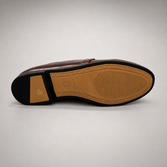 Brown loafer rear view showing a metal accent across the vamp