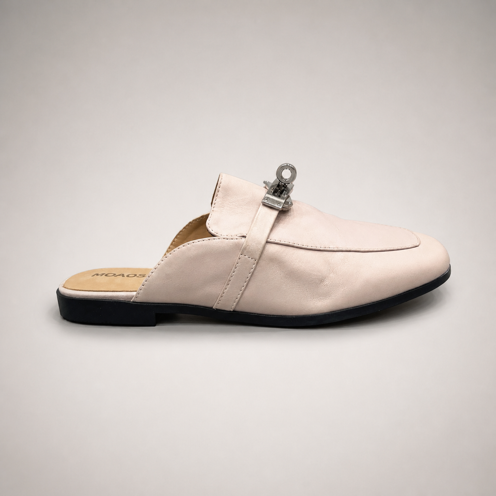 Ivory mule loafer side profile showing an open-back mule construction and metal vamp accent