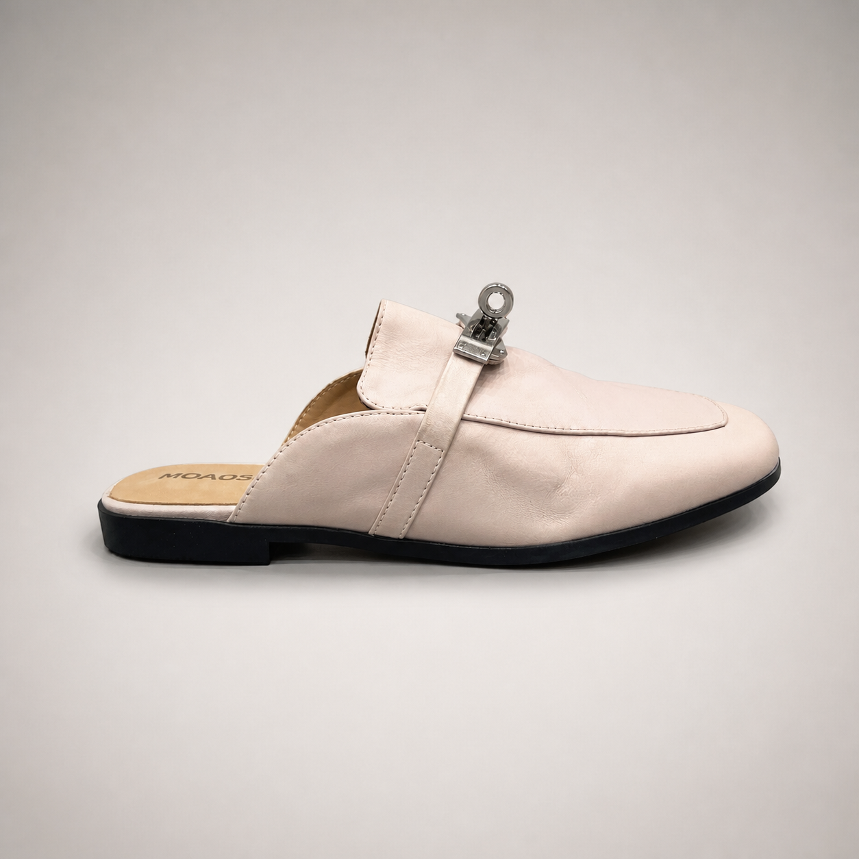 Ivory mule loafer side profile showing an open-back mule construction and metal vamp accent