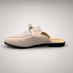 Ivory mule loafer opposite side profile showing an open-back mule construction and metal vamp accent