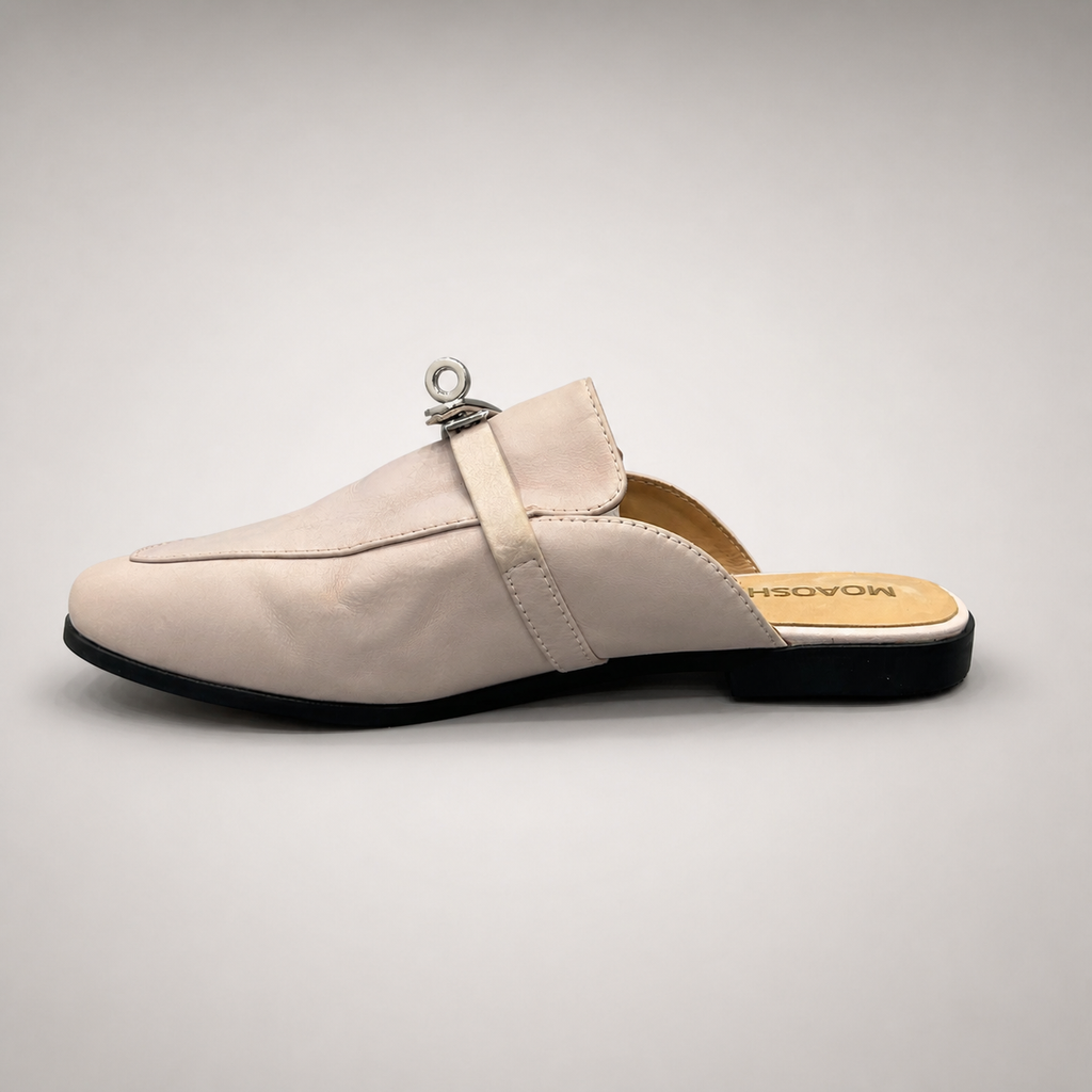 Ivory mule loafer opposite side profile showing an open-back mule construction and metal vamp accent