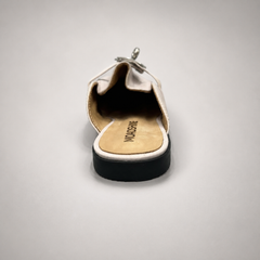 Ivory mule loafer top view showing an open-back mule construction and metal vamp accent