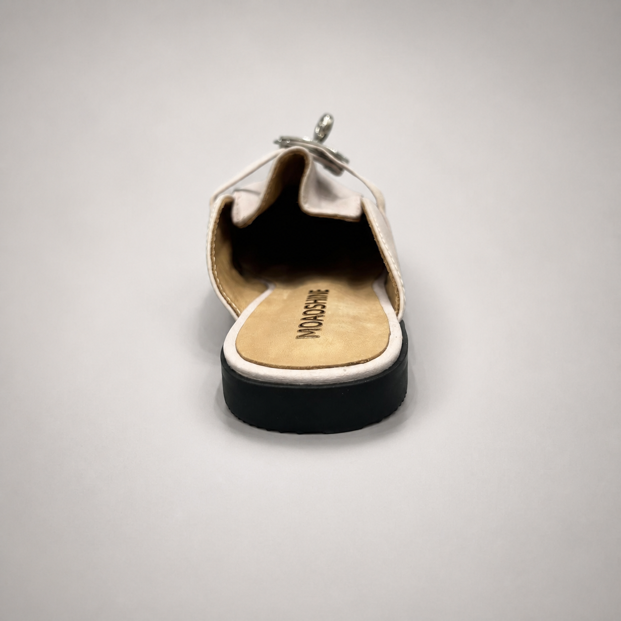 Ivory mule loafer top view showing an open-back mule construction and metal vamp accent