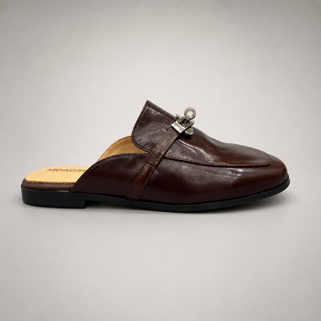 Brown mule loafer side profile showing an open-back mule construction and metal vamp accent