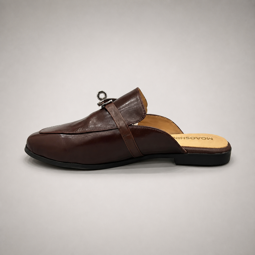 Brown mule loafer opposite side profile showing an open-back mule construction and metal vamp accent