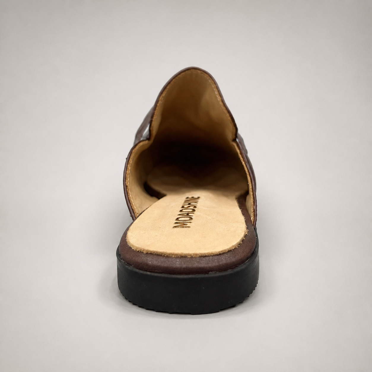 Brown mule loafer top view showing an open-back mule construction and metal vamp accent