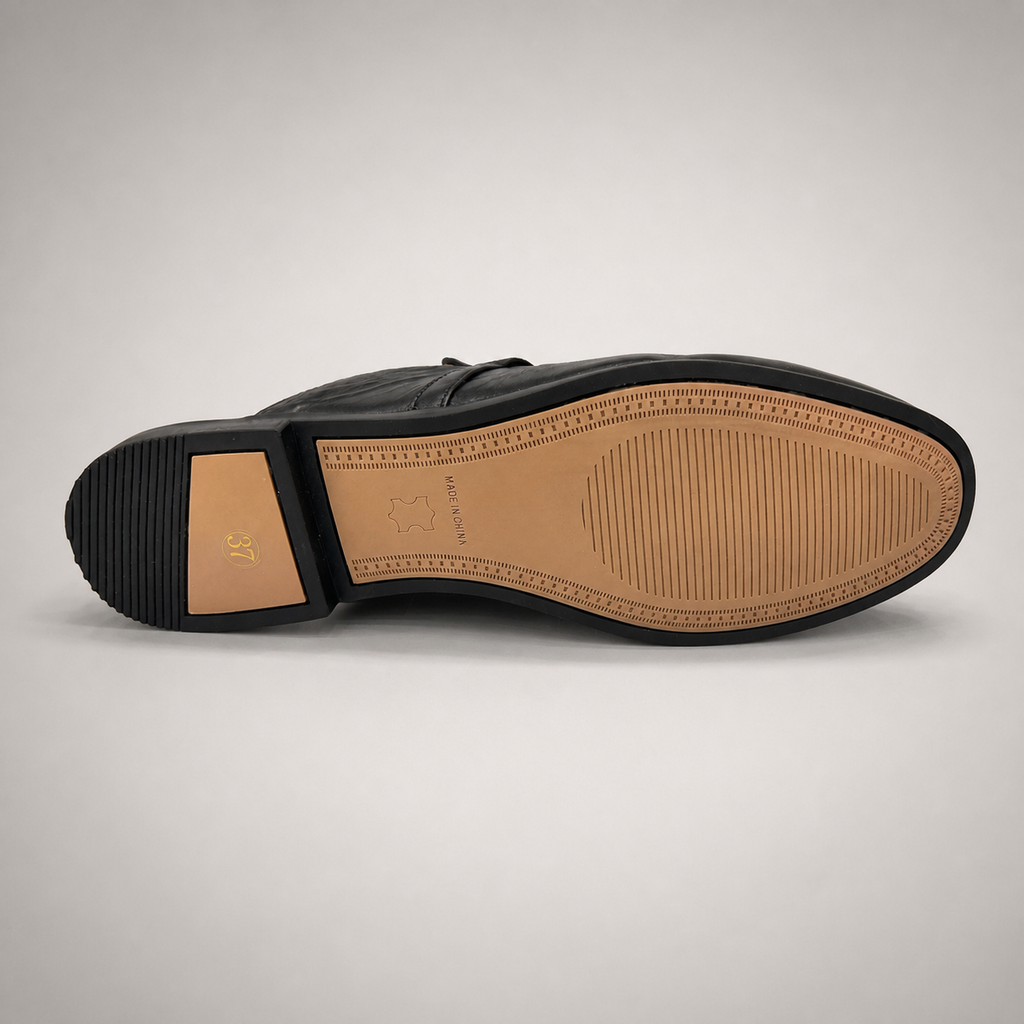 Black mule loafer rear view showing an open-back mule construction and metal vamp accent