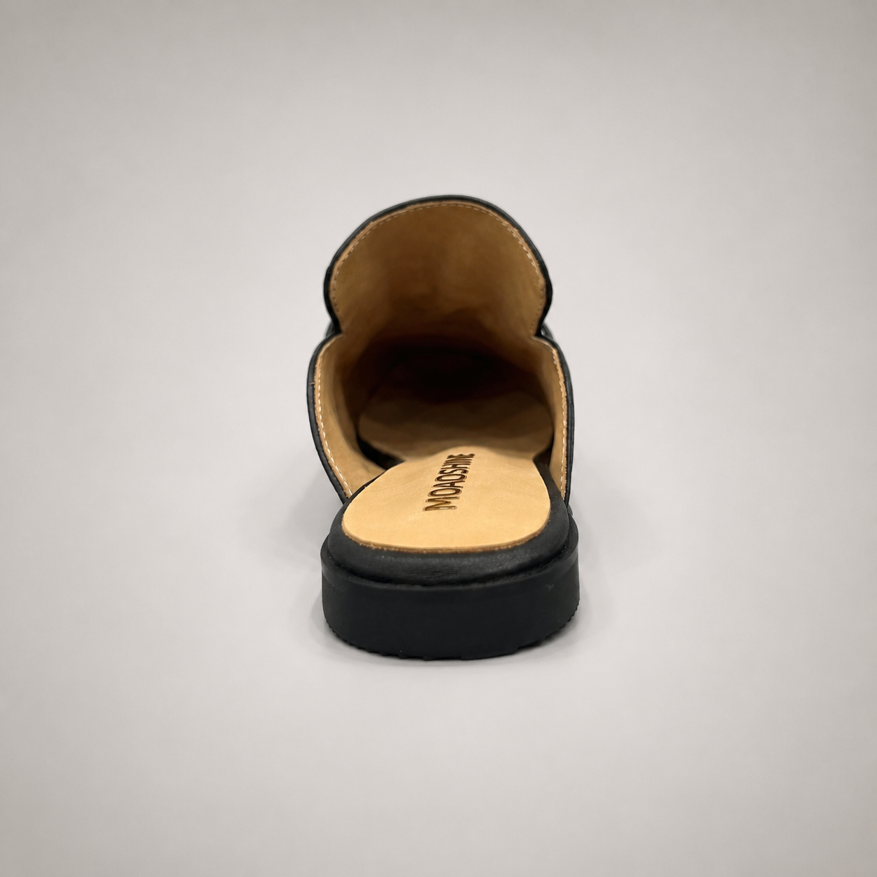 Black mule loafer top view showing an open-back mule construction and metal vamp accent