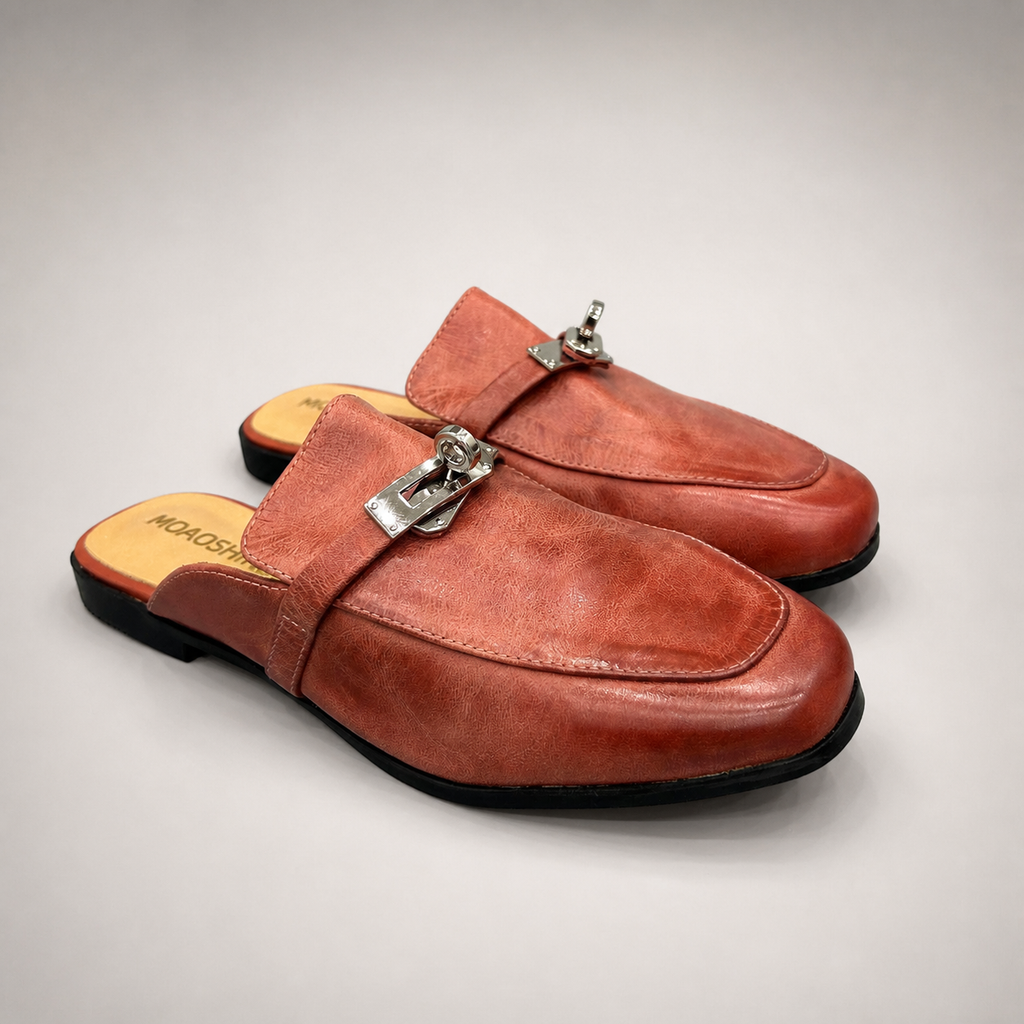 Rust mule loafer pair three-quarter view showing an open-back mule construction and metal vamp accent