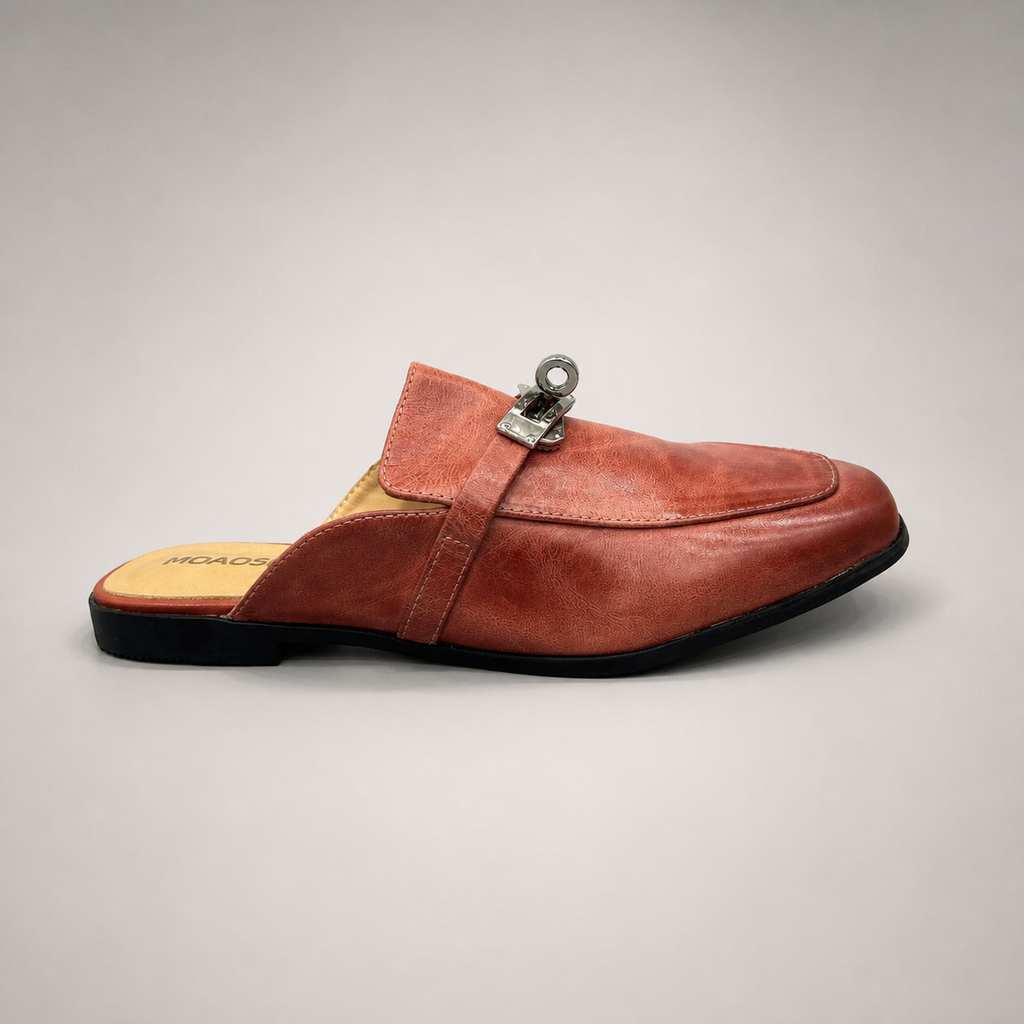 Rust mule loafer side profile showing an open-back mule construction and metal vamp accent