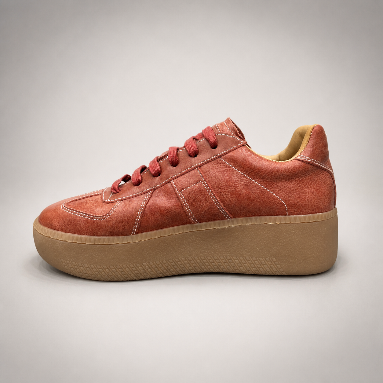 Rust platform sneaker opposite side profile showing a lace-up upper and raised platform sole