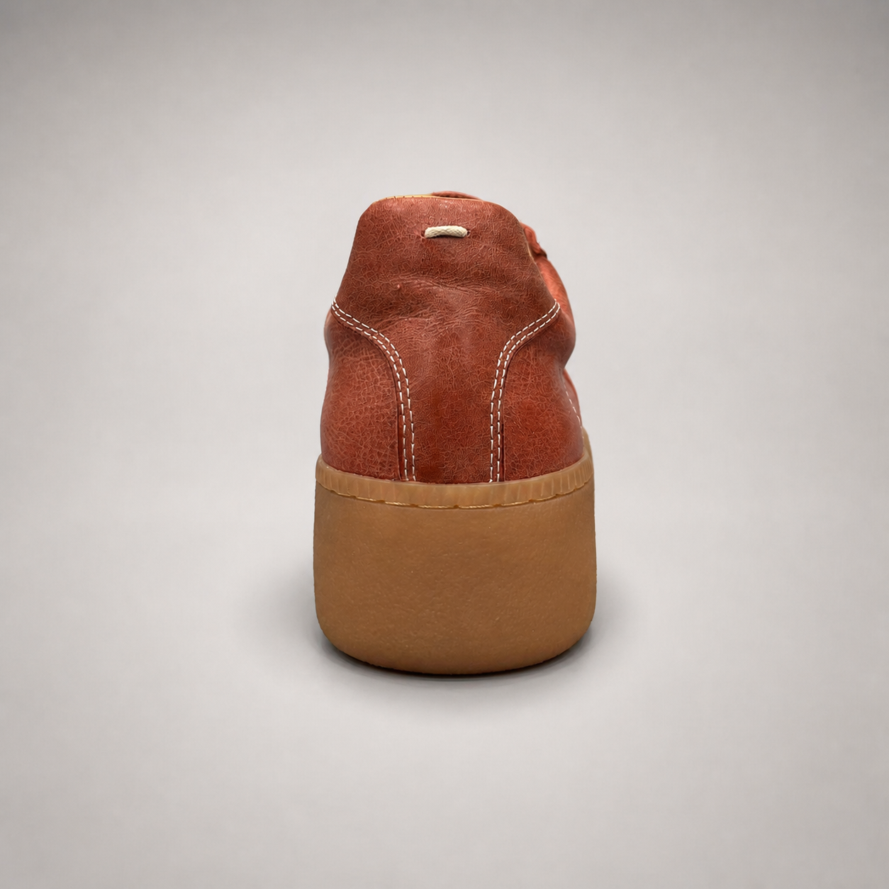 Rust platform sneaker rear view showing a lace-up upper and raised platform sole