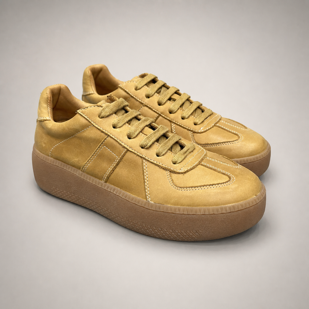 Tan platform sneaker pair three-quarter view showing a lace-up upper and raised platform sole