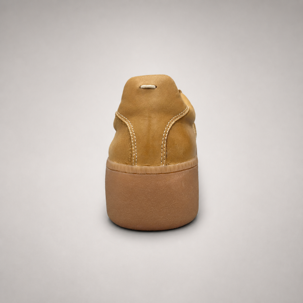 Tan platform sneaker rear view showing a lace-up upper and raised platform sole