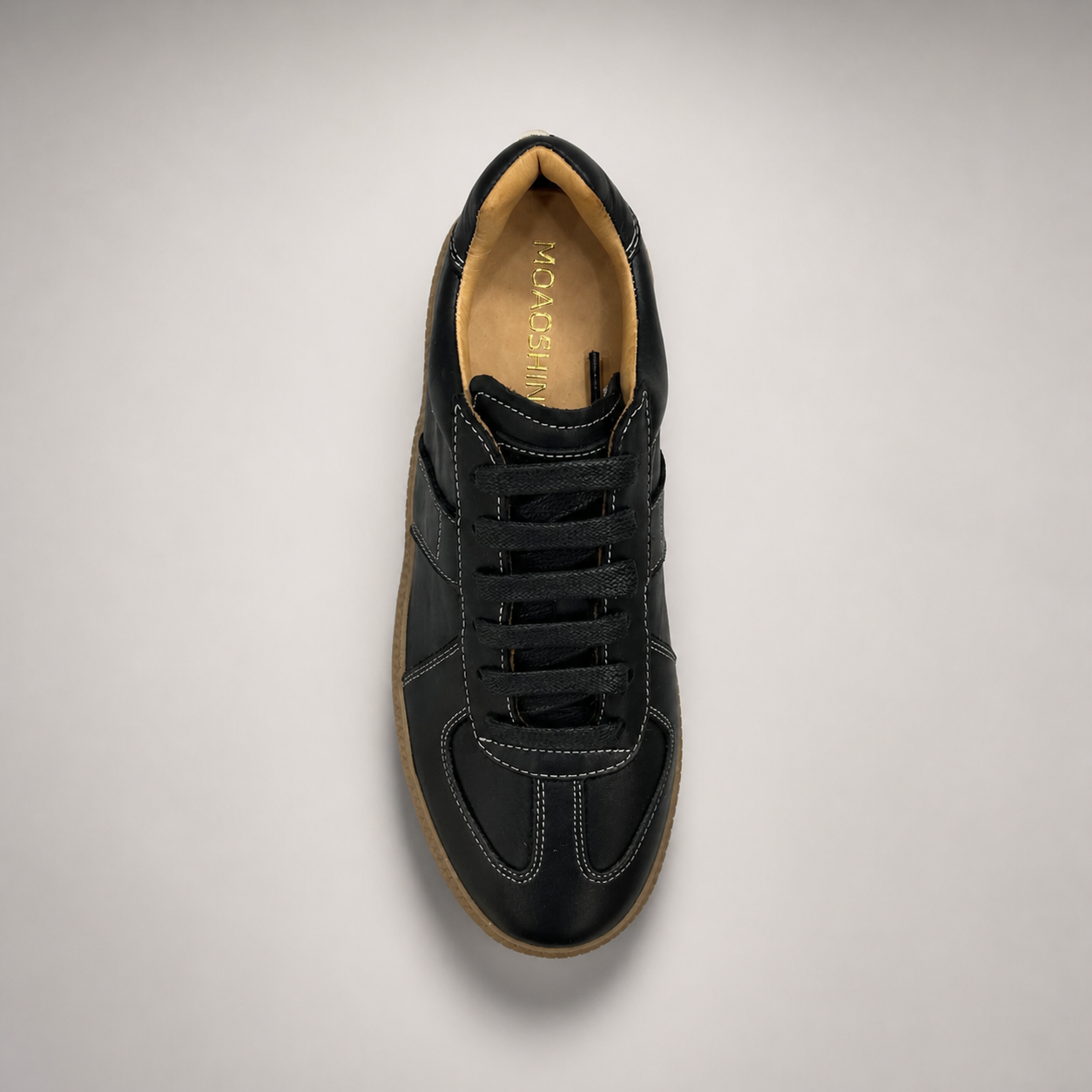 Black platform sneaker top view showing a lace-up upper and raised platform sole