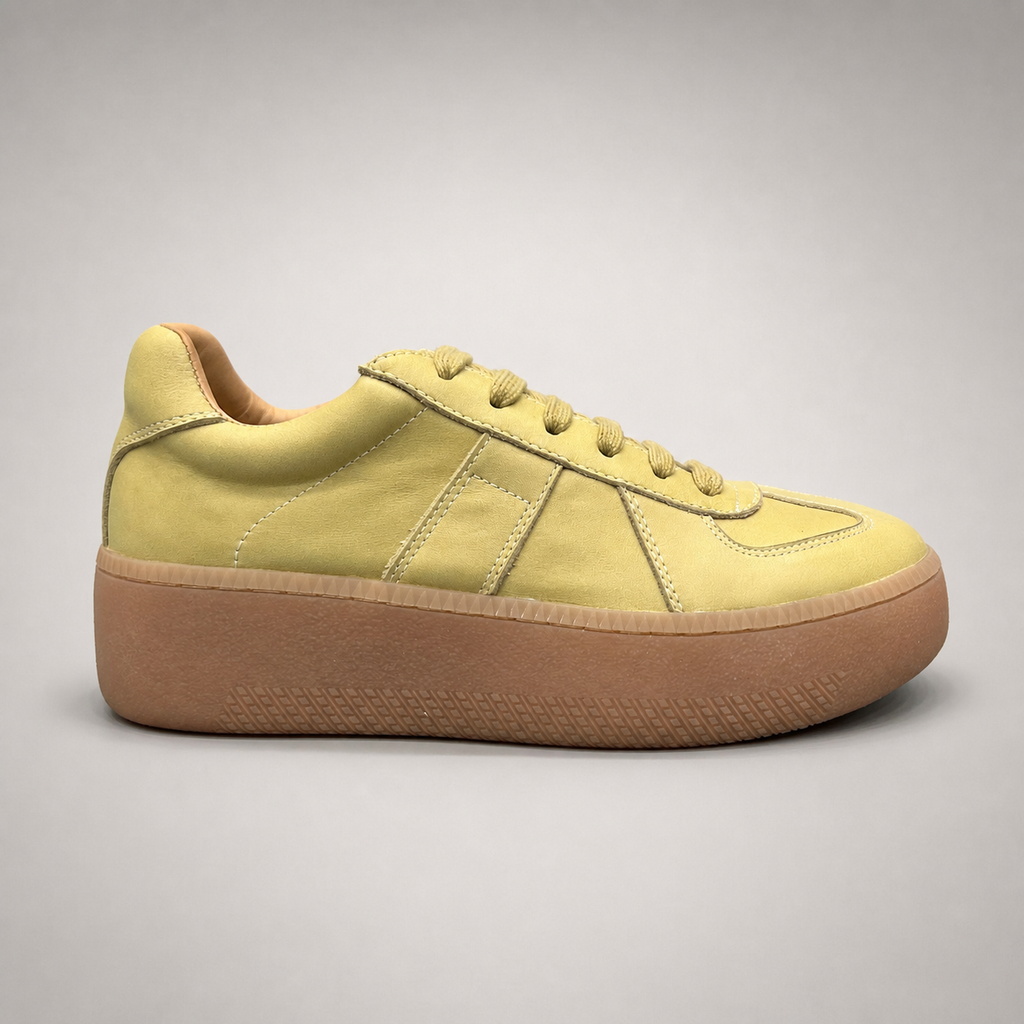 Yellow platform sneaker side profile showing a lace-up upper and raised platform sole