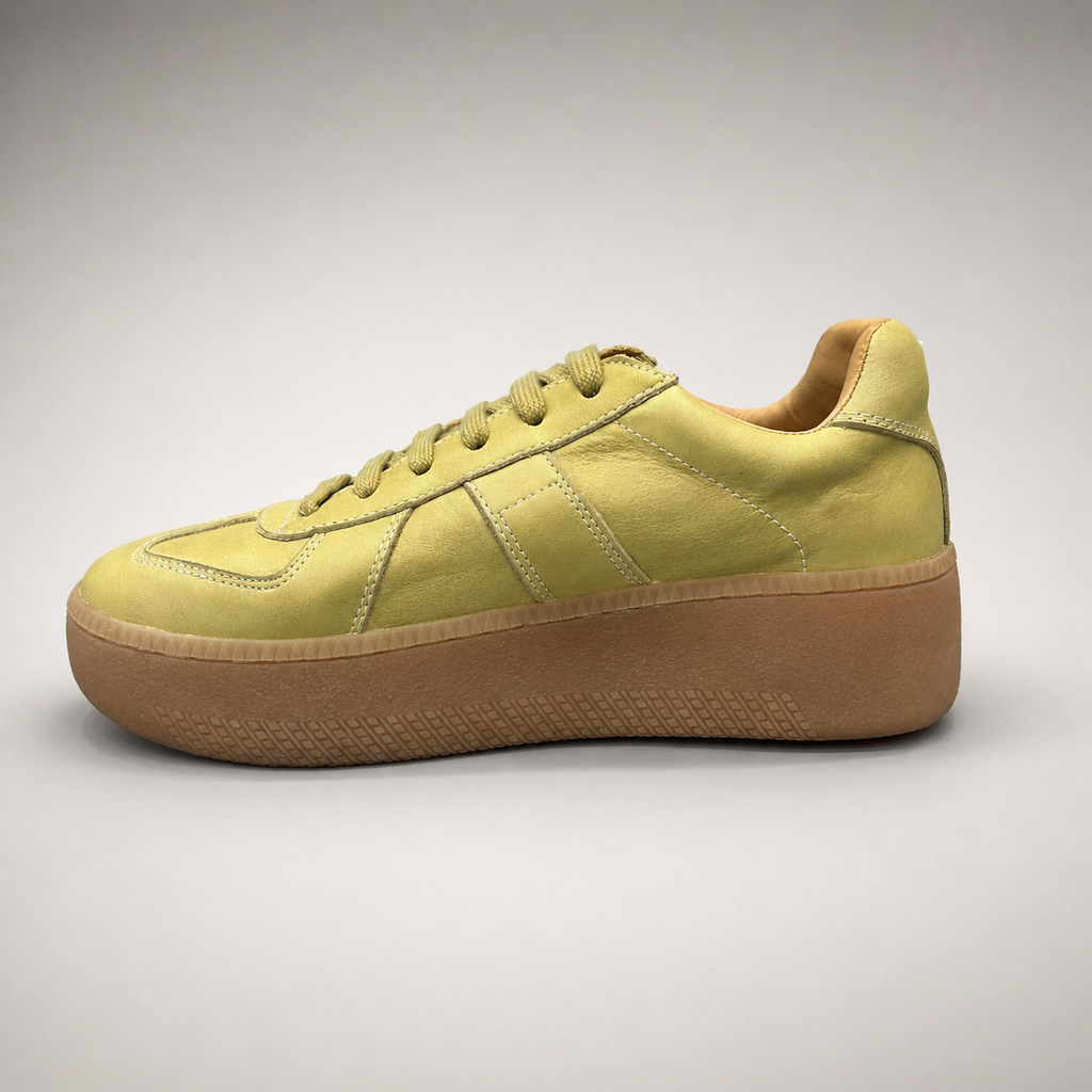 Yellow platform sneaker opposite side profile showing a lace-up upper and raised platform sole