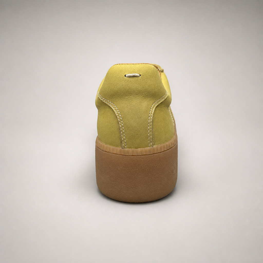 Yellow platform sneaker top view showing a lace-up upper and raised platform sole