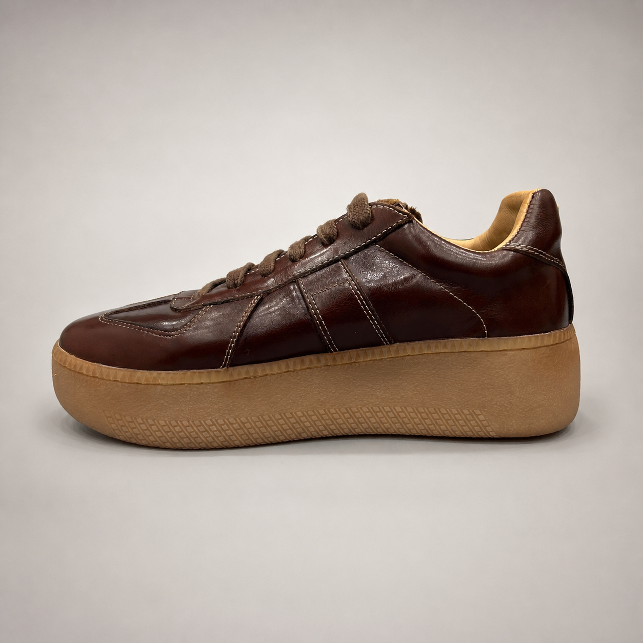 Brown platform sneaker opposite side profile showing a lace-up upper and raised platform sole