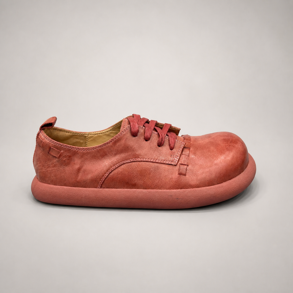Rust low-top sneaker side profile showing a lace-up low-top construction