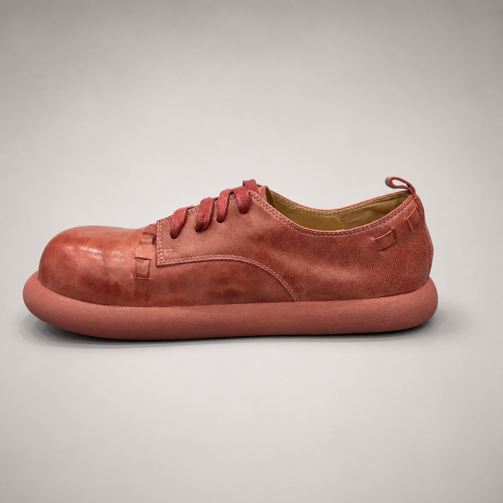 Rust low-top sneaker opposite side profile showing a lace-up low-top construction