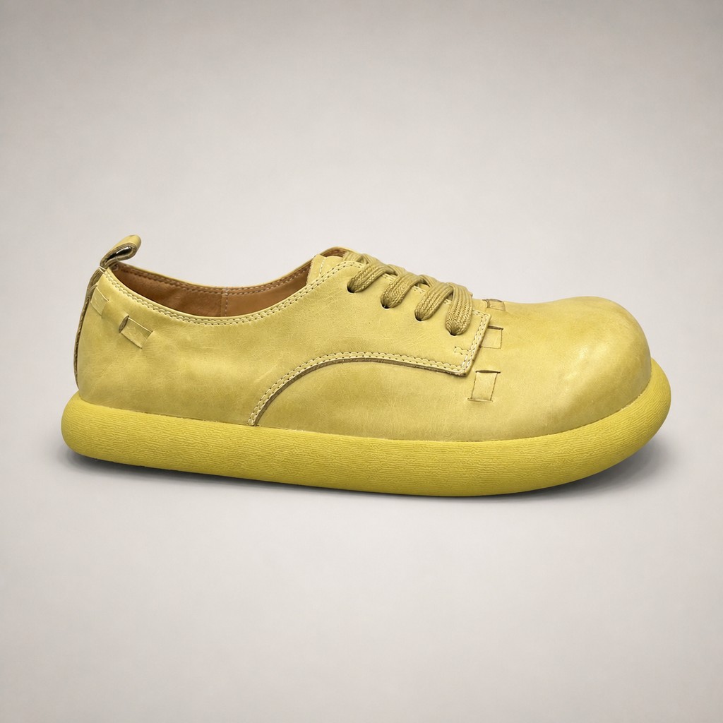 Yellow low-top sneaker side profile showing a lace-up low-top construction