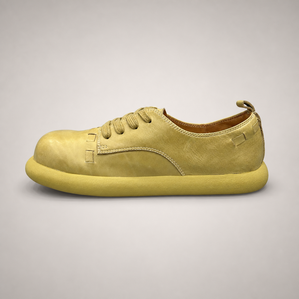 Yellow low-top sneaker opposite side profile showing a lace-up low-top construction