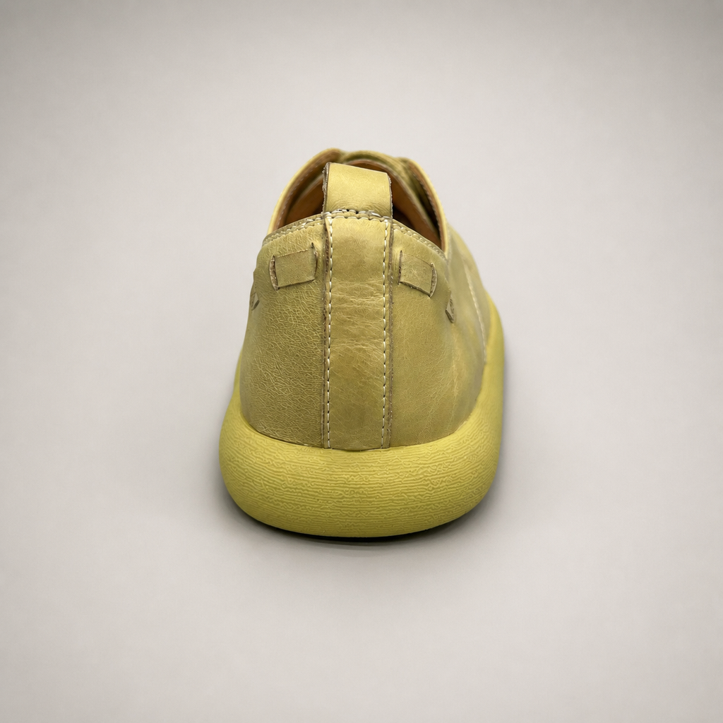 Yellow low-top sneaker rear view showing a lace-up low-top construction