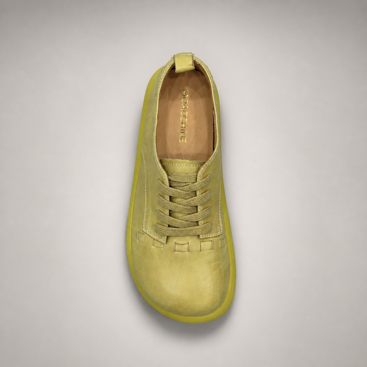 Yellow low-top sneaker outsole view showing the rubber outsole