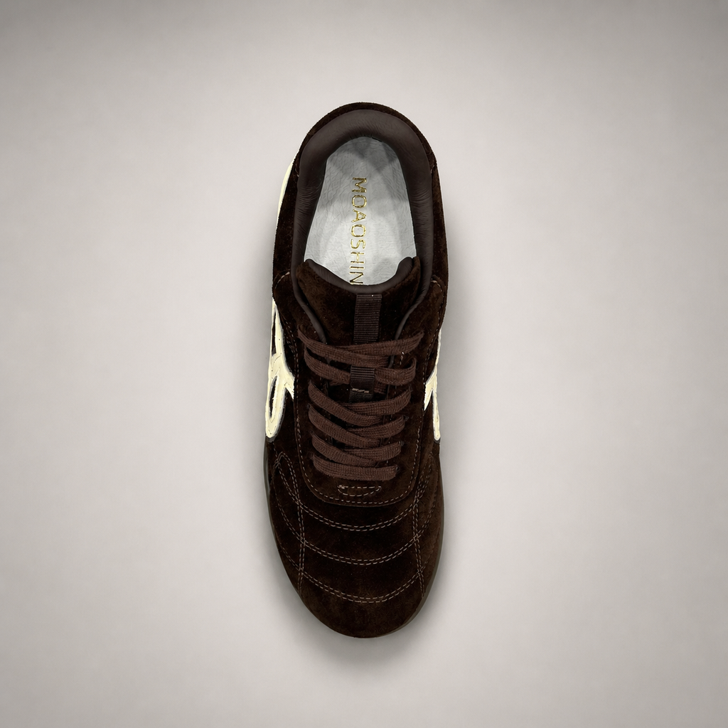 Dark Brown soccer shoe top view showing a lace-up upper and molded outsole studs