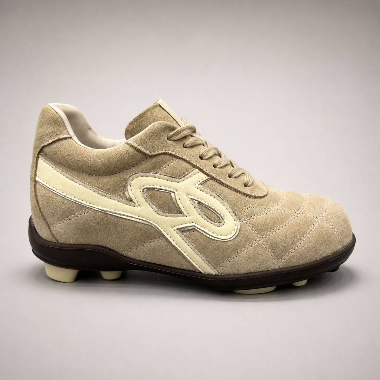 Beige soccer shoe second pair angle showing a lace-up upper and molded outsole studs