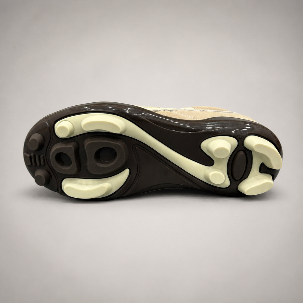 Beige soccer shoe outsole view showing the rubber outsole