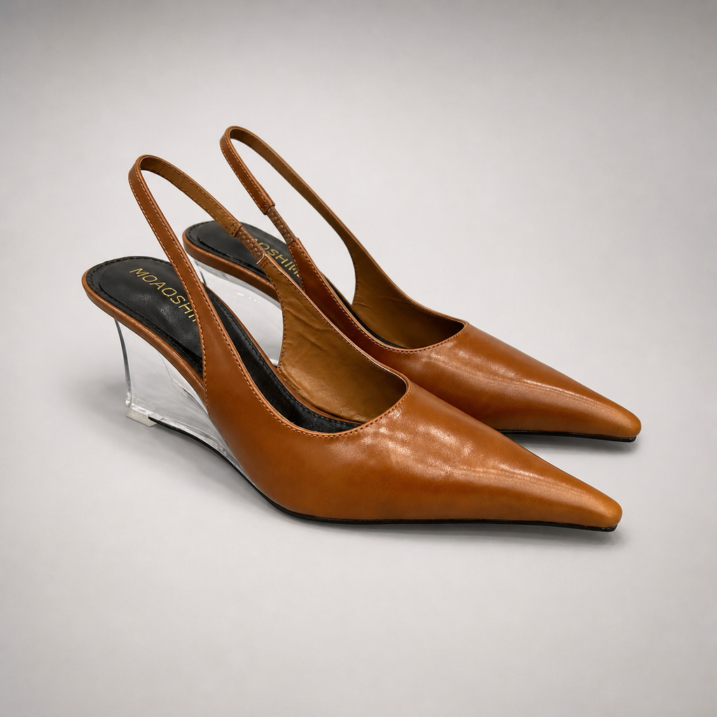 Brown wedge slingback pump pair three-quarter view showing a pointed toe, slingback strap, and clear wedge heel