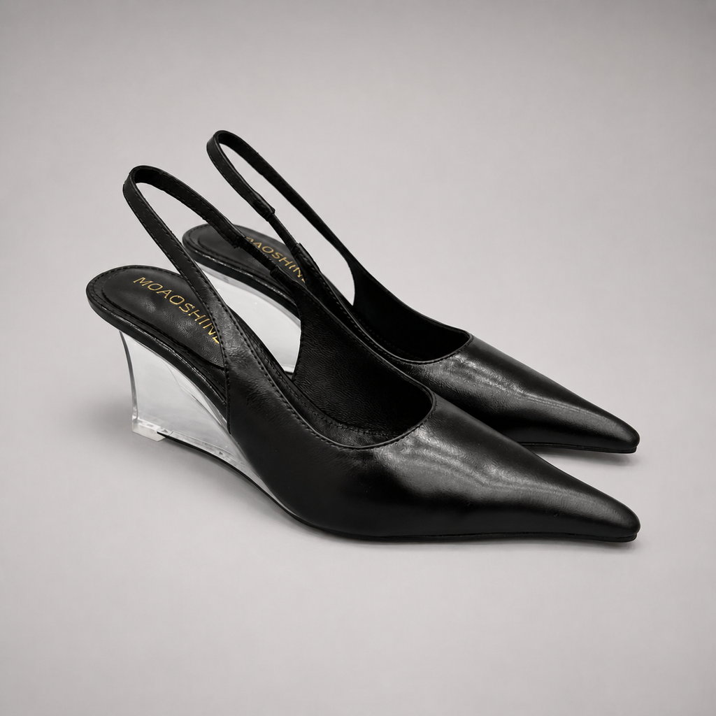 Black wedge slingback pump pair three-quarter view showing a pointed toe, slingback strap, and clear wedge heel