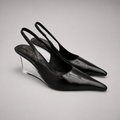 Black wedge slingback pump pair three-quarter view showing a pointed toe, slingback strap, and clear wedge heel