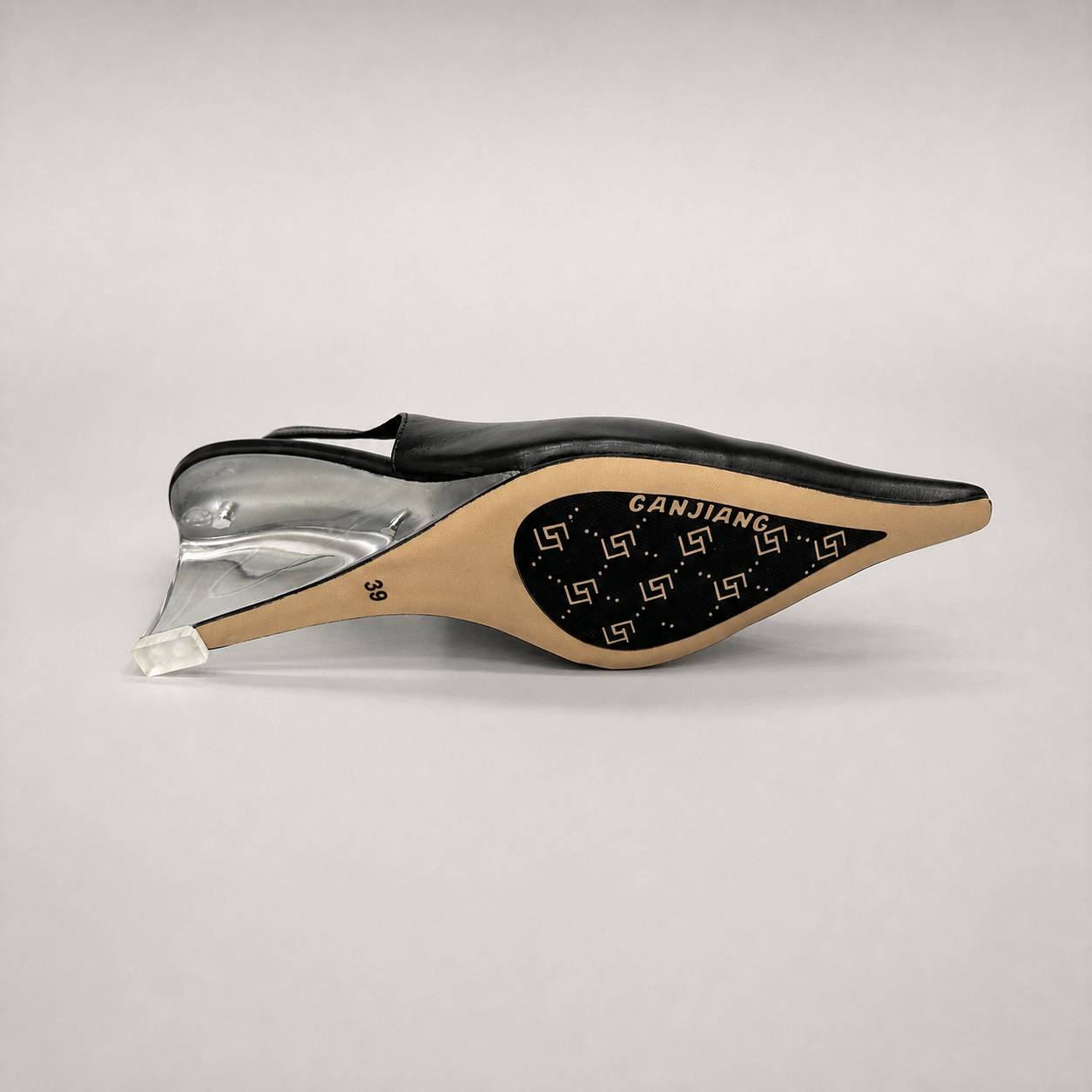 Black wedge slingback pump top view showing a pointed toe, slingback strap, and clear wedge heel