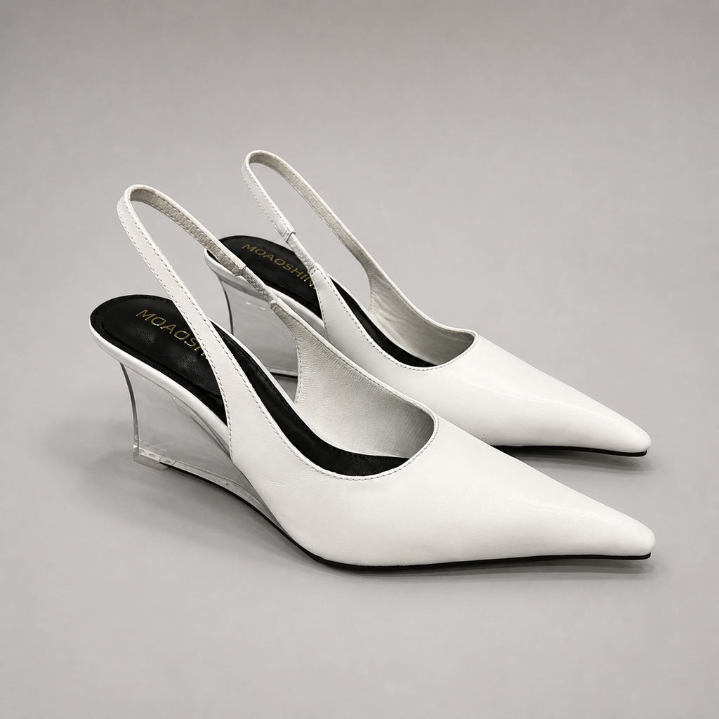 White wedge slingback pump pair three-quarter view showing a pointed toe, slingback strap, and clear wedge heel