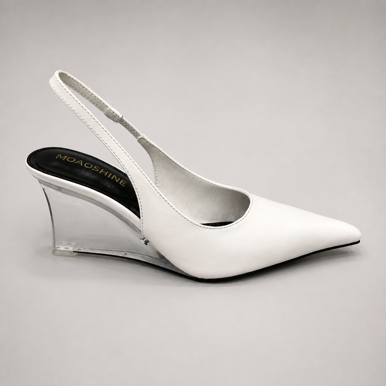 White wedge slingback pump side profile showing a pointed toe, slingback strap, and clear wedge heel