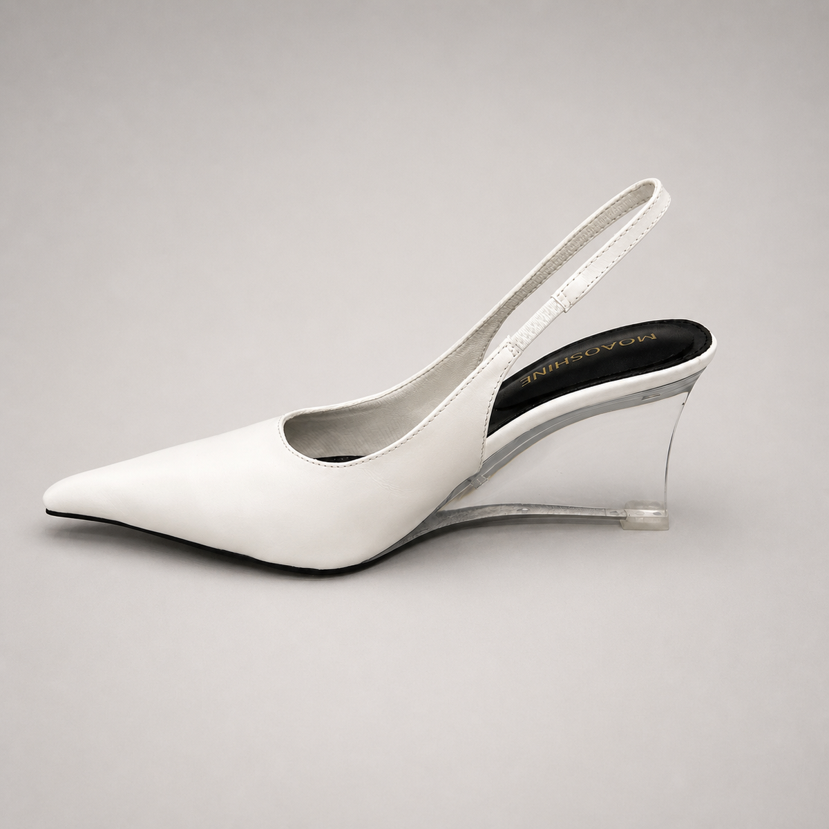 White wedge slingback pump opposite side profile showing a pointed toe, slingback strap, and clear wedge heel