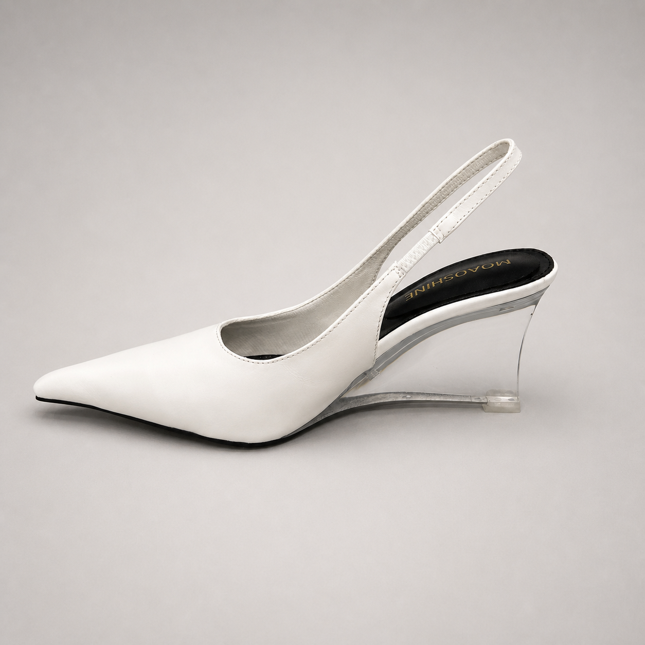 White wedge slingback pump opposite side profile showing a pointed toe, slingback strap, and clear wedge heel