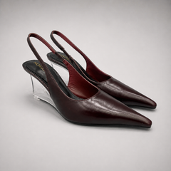 Burgundy wedge slingback pump pair three-quarter view showing a pointed toe, slingback strap, and clear wedge heel