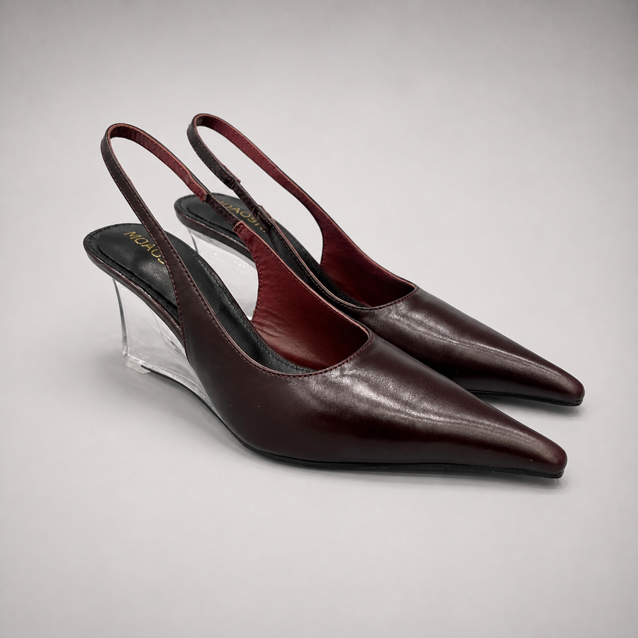 Burgundy wedge slingback pump pair three-quarter view showing a pointed toe, slingback strap, and clear wedge heel