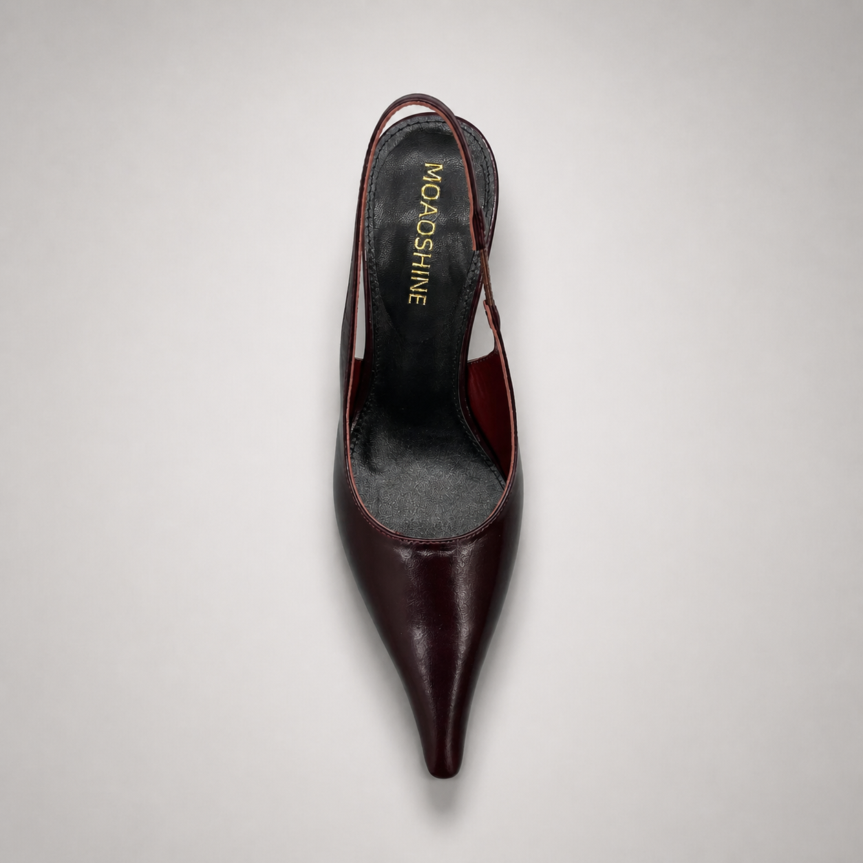 Burgundy wedge slingback pump top view showing a pointed toe, slingback strap, and clear wedge heel