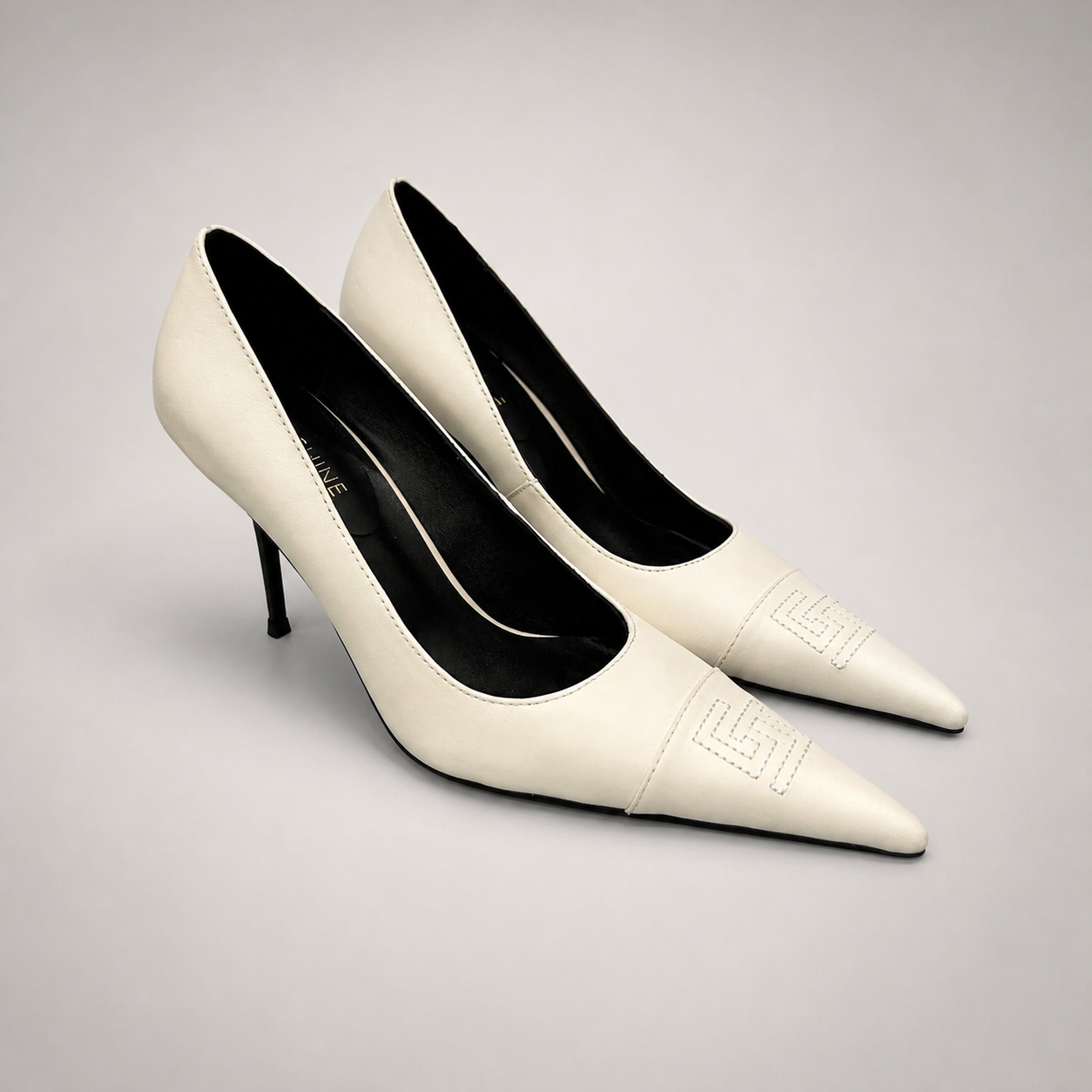 White pump pair three-quarter view showing a pointed toe