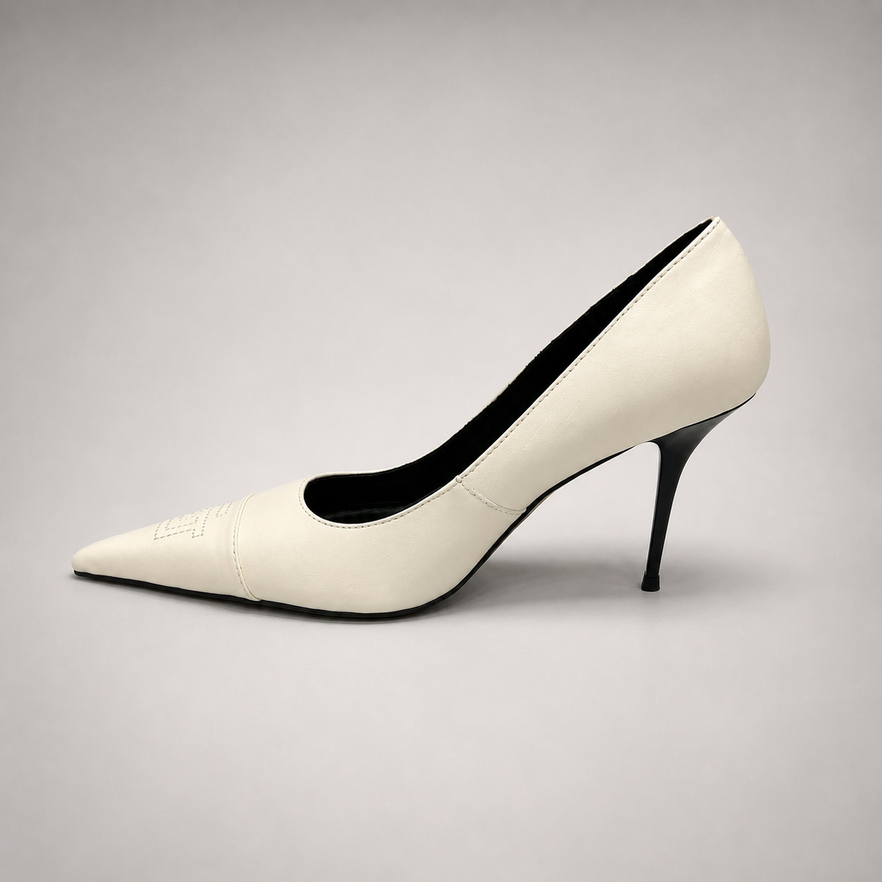White pump opposite side profile showing a pointed toe