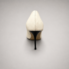 White pump rear view showing a pointed toe